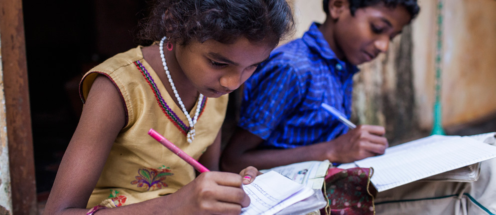 India. Karnataka. Udupi district. Keerthana (9) and Sharan (12) are doing their homework in front of their house in the village of Ramanagara. 26.11.2014